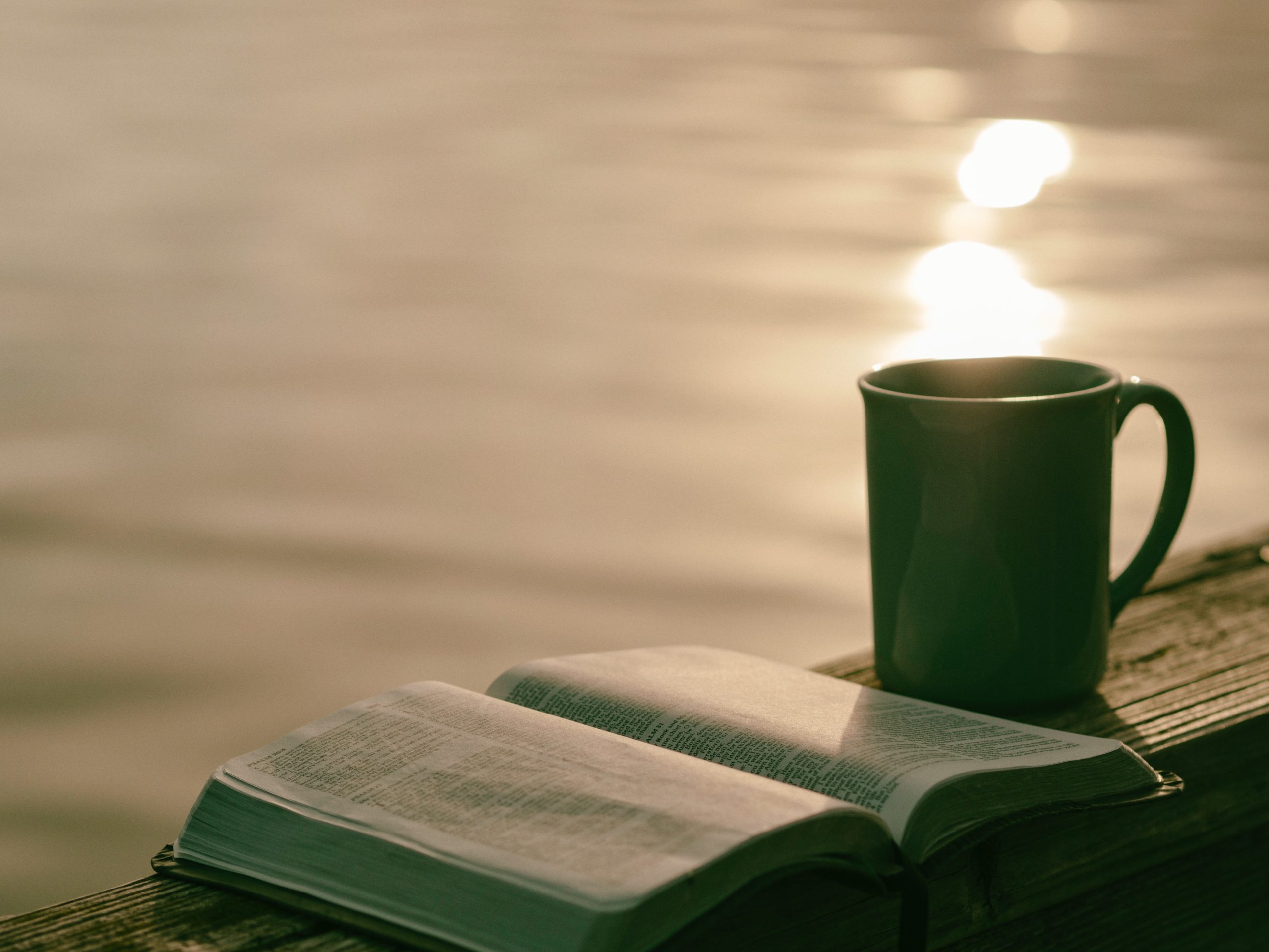 Bible, mug, calm water