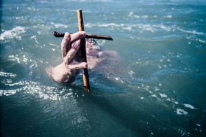 holding cross in water