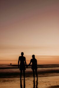 Couple holding hands on beach