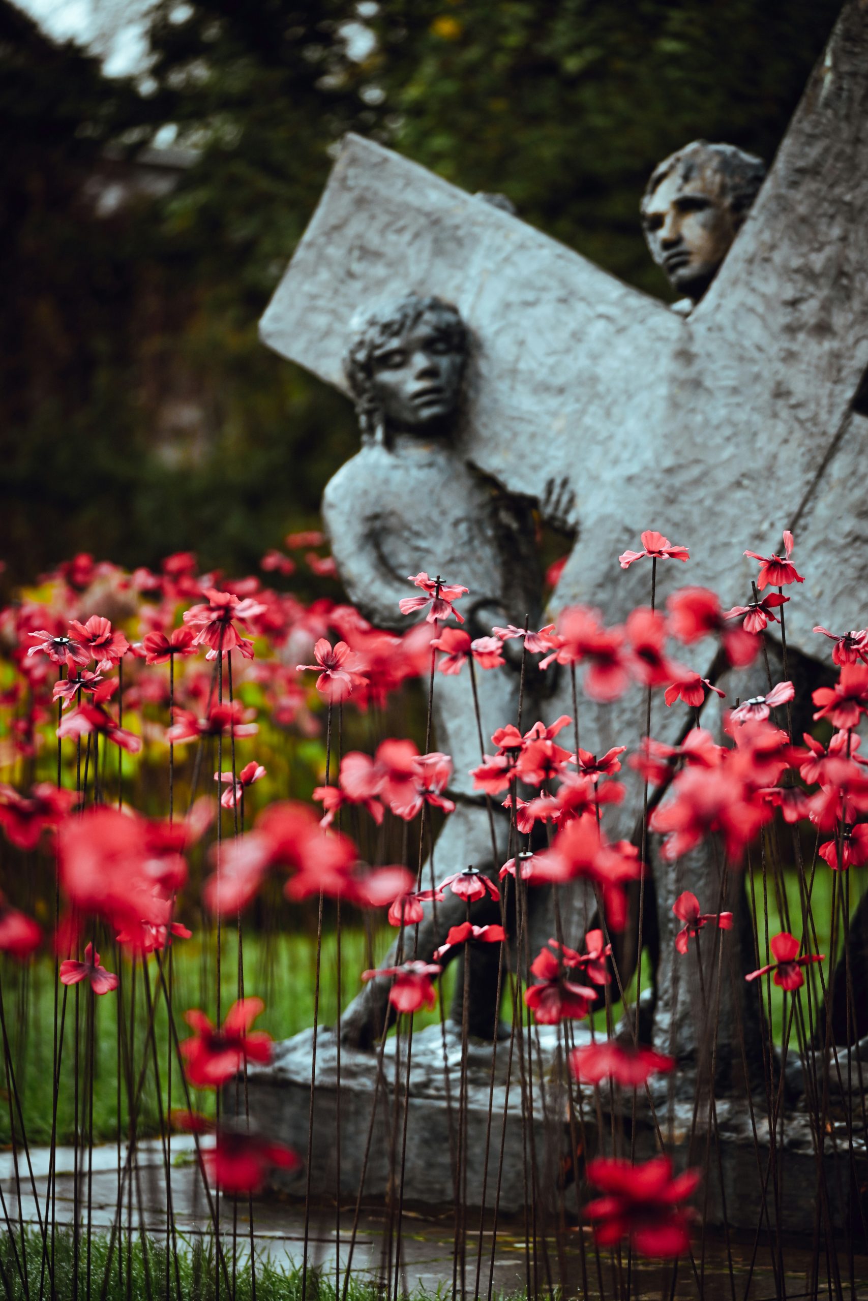 Statue of figures carrying a stone cross